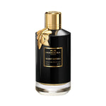 Mancera Musky Garden Eau de Parfum – elegant floral fragrance with notes of rose, jasmine, and white musk, presented in a 120ml glossy black bottle adorned with a gold flower charm and gold accents, embodying femininity and refined luxury.
